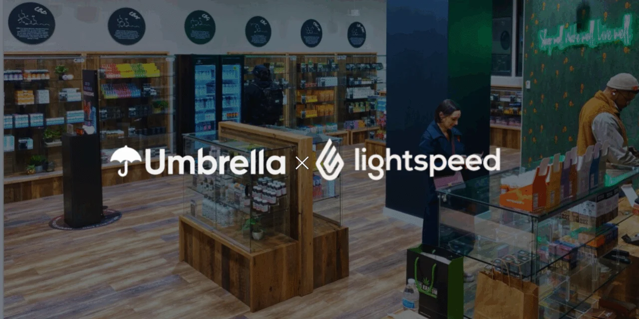 Retail store interior with staff at the counter and Umbrella × Lightspeed branding